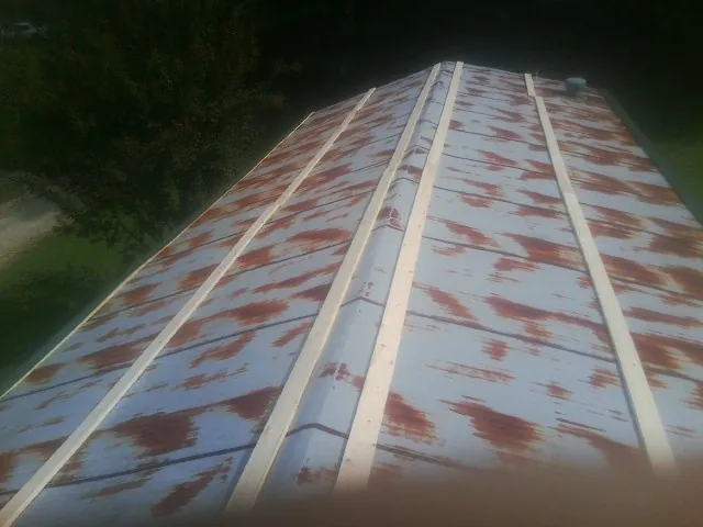Rusted metal roof panels with new wood purlins before replacement — Storm Damage Roof Repair in Trivoli by Roofing Brothers