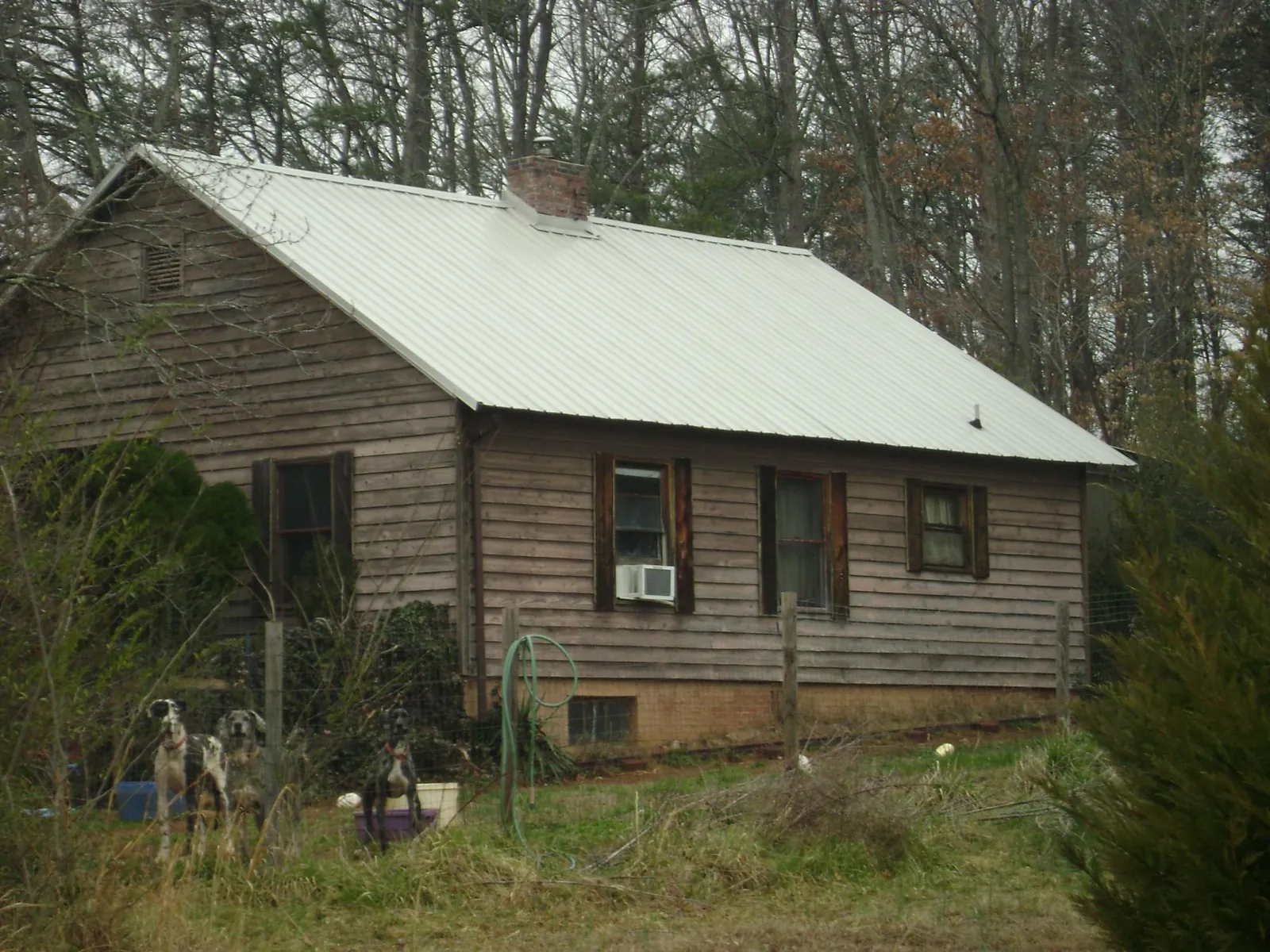 White metal roof on an old wood sided farmhouse, from a Metal Roof Installation job in Trivoli